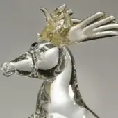 Glass reindeer sculpture, clear with gray swirls, featuring a textured amber glass crown and dynamic rearing pose.