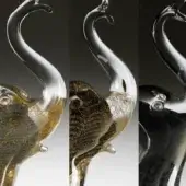 Glass elephant sculptures, clear & gold, dark gold, and black with gold flecks, stylized elongated forms with curved trunks.