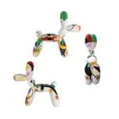 Juliarte balloon dog sculptures, white glossy ceramic, geometric patterns in green, yellow, blue, red, black, and orange hues.