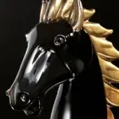 Horse head sculpture, black resin with gold leaf detailing, stylized profile with metallic accents and textured mane.
