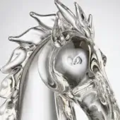 Transparent glass horse head sculpture, swirling patterns, profile view with flowing mane, light gray background, soft diffused lighting.