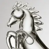 Glass horse sculpture, clear molded glass, dynamic rearing pose with flowing mane and tail against a light gray backdrop.