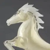 Glass horse sculpture, translucent gold tone, dynamic rearing pose with white mane and tail, smooth glossy finish, stylized form.