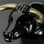 Black ox head sculpture with gold horns, featuring a high-gloss finish and minimalist, stylized design against a dark gray backdrop.