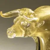 Glass ox sculpture, amber-gold translucent, detailed horns and facial features, swirling texture, studio lighting, gradient background.