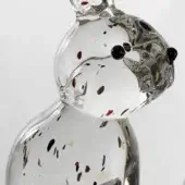 Glass rabbit sculpture, clear with red, brown, blue speckles, featuring elongated form, black bead eyes, upright ears, glossy finish.
