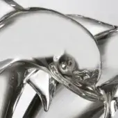 Glass dolphin sculpture, clear acrylic, intertwined leaping pose with detailed facial features and reflective polished finish.