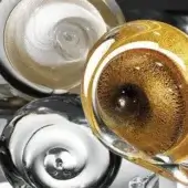 Glass sculptures, spiral patterns, transparent gold, silver-white, dark gray, blown glass, smooth glossy finish, deliberate composition.