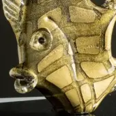 Glass fish sculpture, black and gold mosaic, rounded head with clear protrusion, glossy finish, studio lighting, dark background.
