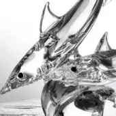 Glass shark sculptures, clear polished finish, dynamic overlapping composition with detailed fins and teeth on a light gray background.