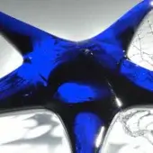 Glass sea star sculpture, saturated blue glaze, organic form with curved protrusions and crackled clear glass sections, rippled texture.