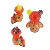 Teddy sculptures, translucent red-orange resin, stylized bear forms with graffiti markings; poses include seated, standing with raised and lowered arms.