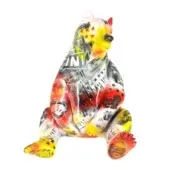Ceramic bear sculpture covered in Porsche racing imagery, featuring red, yellow, black & white collage of cars, logos, and text on white background.