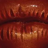 Red and gold textured surface with undulating vertical ridges, resembling lips, featuring reflective highlights and a glossy finish.
