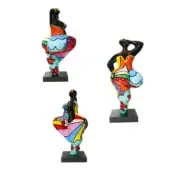 Juliarte sculptures, ceramic and resin, depict dancing female figures with raised arms; two are multi-colored, one is black, each with a red flower.