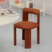 Superior Miniforms Amia chair upholstered in textured reddish-brown fabric with uniquely crossed legs and clean lines