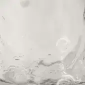 Cristallo glass, clear blown glass with swirling patterns, displays a reflective, marbled surface and organic, fluid form.