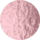 Textured pinkish-gray surface within a circle, set against dark olive-green; repeating leaf-like pattern with dark speckles and a matte finish.