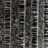 Crystal Rugiada rug, clear cylindrical fibers, dark honeycomb structure, grayscale palette, dense textural surface, three-dimensional design.