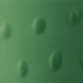 Textured green surface with raised oval shapes, granular matte finish, diffused lighting, and monochromatic color scheme.