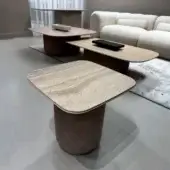 Elegant Costantini Pietro Clou coffee table with matte stone tabletop and warm fabric-covered base exhibiting a contemporary finish
