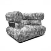 Modular armchair, black and white geometric fabric, three-part cushioned design with rectangular base and curved backrest.