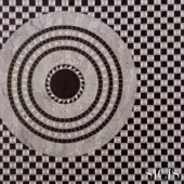 Circular mosaic design with concentric gray and white triangular tiles against a black and white diamond tile background, featuring the SICIS logo.
