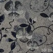 Sicis Dolium Blue mosaic fabric displays floral and vine motifs in gray and black tesserae, with a textured, three-dimensional pattern and SICIS branding.
