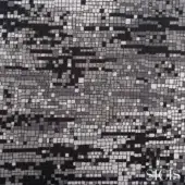 Sicis Numen silver mosaic tile surface with gray, black, and silver square tesserae forming an abstract facial pattern and branded script.