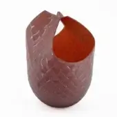 Sculptural glass vase, purple with reddish-brown interior, featuring an irregular woven texture and dramatically curved, jagged rim.