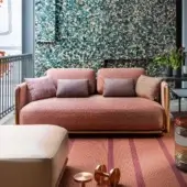 Superior Giorgetti Moorea sofa with pewter painted stainless steel and teak, upholstered in muted coral textile with a subtly nubby finish