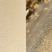 Textured composition of beige speckles and brown-gray streaks with golden flakes, layered effect, diffused lighting.