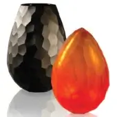 Faceted matte black and orange vases, teardrop shape, studio shot, crystalline texture, angular design, reflective surface, contrasting colors.