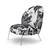 Accent chair, black and white mosaic upholstery, rounded silhouette with tapered brushed metal legs and high back.