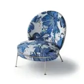 Armchair, blue mosaic fabric, rounded form with tapered metal legs and floral pattern upholstery in a studio setting.