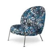 Accent chair, dripping blue fabric, rounded teardrop back, silver metal legs, mosaic pattern, modern sculptural design, white background.
