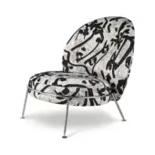 Armchair, black and white matis fabric, rounded high back with mosaic pattern, polished metal angled legs, modern sculptural design.
