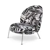Accent chair, black and white zebra print upholstery, rounded shell with polished metal legs, contemporary studio shot.