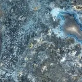 Blue Vetrite surface with concentric rings, beige veins, and gold accents; textured stone or agate pattern, Sicis brand.