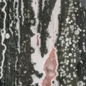 Abstract layered texture in gray, black, white, blush pink, and terracotta with circular inclusions and linear cracks, resembling agate or marble.