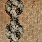 Textured pattern with gray columns on warm brown rectangular tiles, featuring a mottled finish and subtle "columna brown" text inscription.