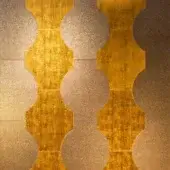 Metallic wall panel, gold and bronze tones, vertically stacked oval tiles with distressed texture; “sicis” text visible.