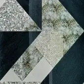 Grey mosaic tile pattern with irregular triangular and rectangular sections, featuring silver and white accents, and textured stone panels.