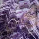 Sicis Vetrite Plum Corundum surface displays geometric lines in purple, beige, and white with translucent layered bands and a polished finish.