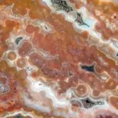 Sicis Vetrite stone surface, yellow-orange punctum pattern, concentric circles with dark inclusions, high gloss finish, organic texture.