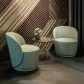 Elegant Sicis Celebrity lounge chair with muted grayish-blue-green textile upholstery and continuously rounded solid wood construction
