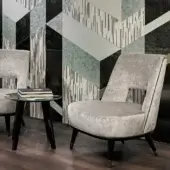 Balanced Sicis Liam lounge chair with muted gray woven textile and lacquered dark wood legs finished with metal end caps