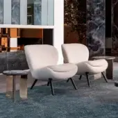 Superior Sicis Niels lounge chair with textured light neutral beige textile upholstery and subtly flared dark-toned wood legs