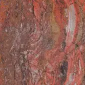 Weathered rock texture displaying crimson, rust, and ochre tones with swirling patterns and deep fissures, exhibiting a marbled, sedimentary composition.