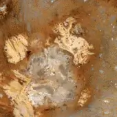 Abstract textured composition of rust orange, ochre yellow, and gray swirling patterns with metallic silver highlights, resembling geological formations.